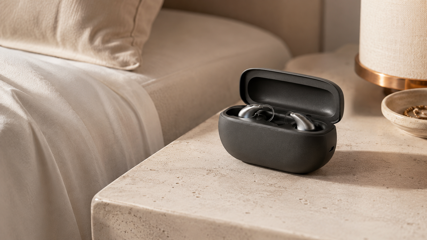 Open hearing aid charging case on a bedside table